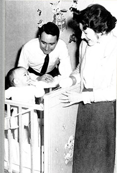 Adoptive parents meet their child for the first time, c. 1960. (National Archives)